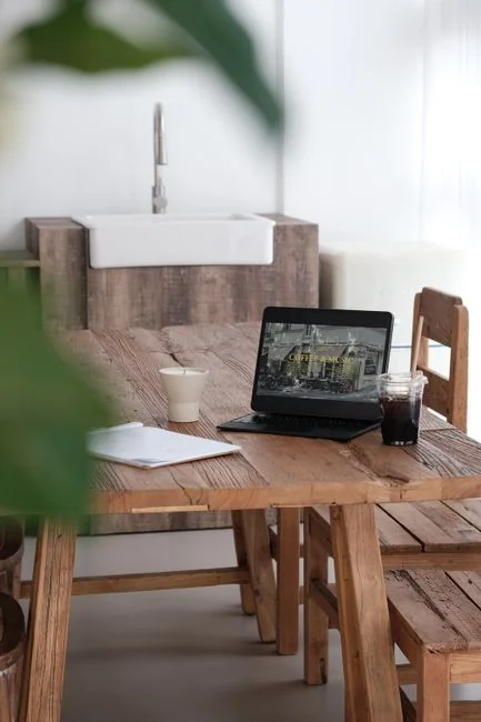 A modern workspace featuring dual computer monitors displaying web design projects, emphasizing technology and productivity.